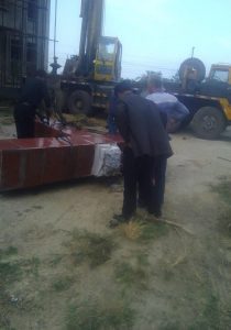Men dismantling a cross
