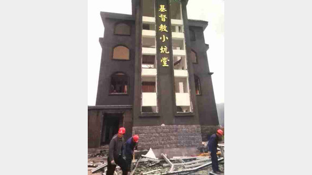 Operai al lavoro per la demolizione della chiesa Xiaokeng 