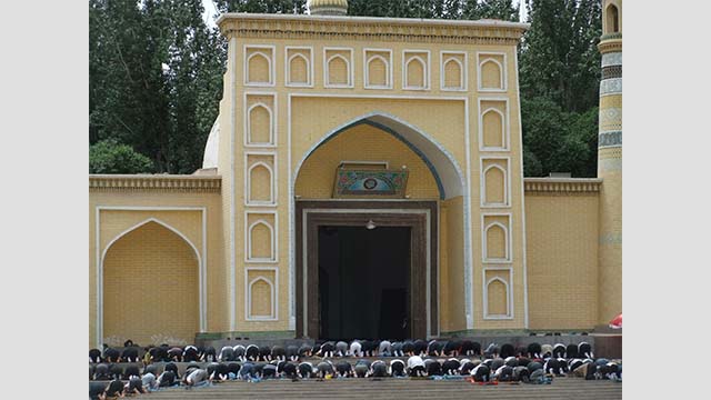 La preghiera del venerdì a Kashgar, nello Xinjiang meridionale nel 2011. I fedeli si riversano sui gradini all’ingresso della principale moschea di Id Kah.