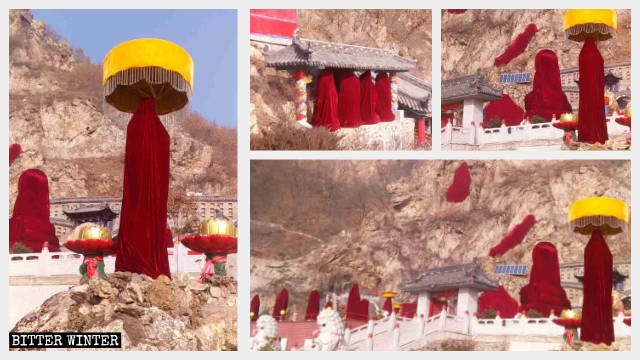 Le statue buddhiste che si trovano all'aperto nella Grotta dei mille Buddha avvolte in teli rossi
