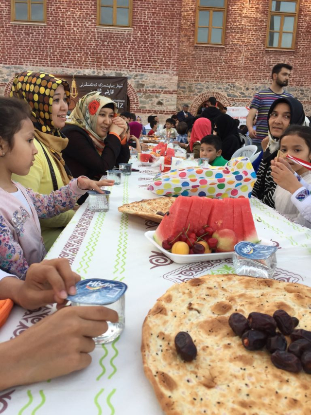 Donne e bambini uiguri, molti dei quali sono vedove e orfani celebrano l’iftar